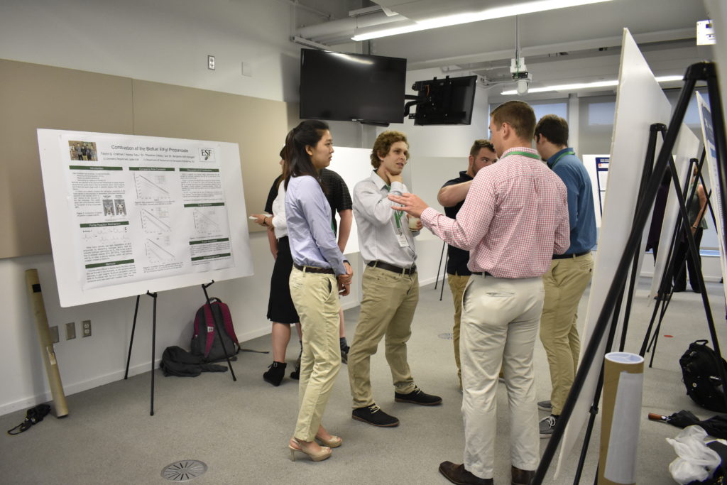 Students talking around posters