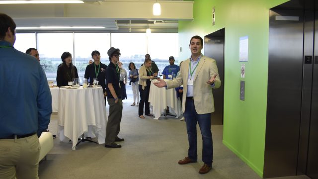 People listening to a talk at SyracuseCoE