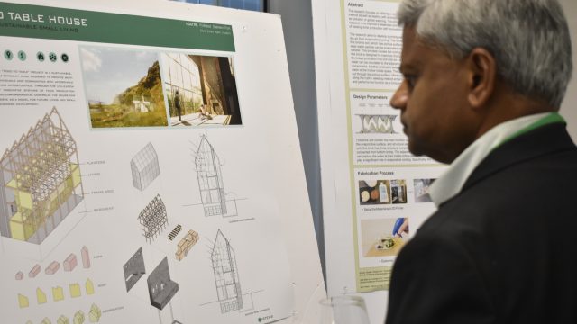 Man Looking at Poster