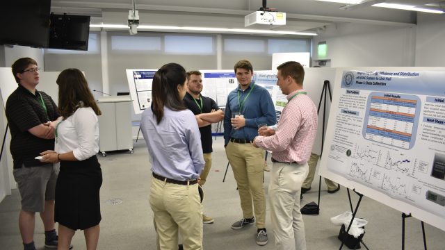 Students talking around posters