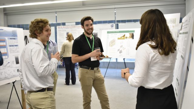People talking near posters