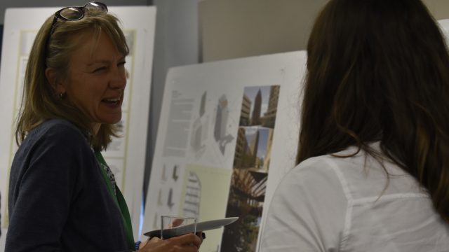 People talking near posters